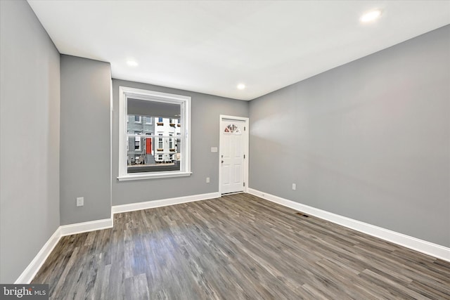 unfurnished room featuring dark hardwood / wood-style floors