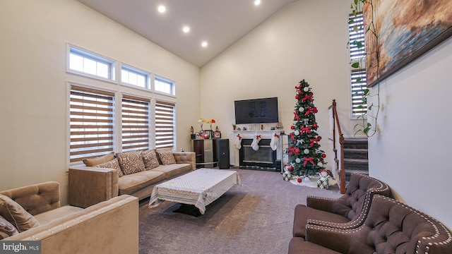 carpeted living room featuring high vaulted ceiling