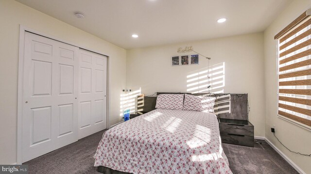 bedroom featuring a closet and dark colored carpet