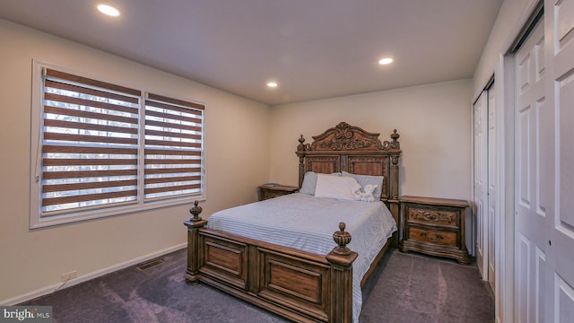 bedroom with dark colored carpet