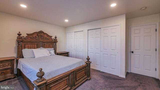 carpeted bedroom featuring two closets