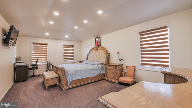 carpeted bedroom with multiple windows and lofted ceiling