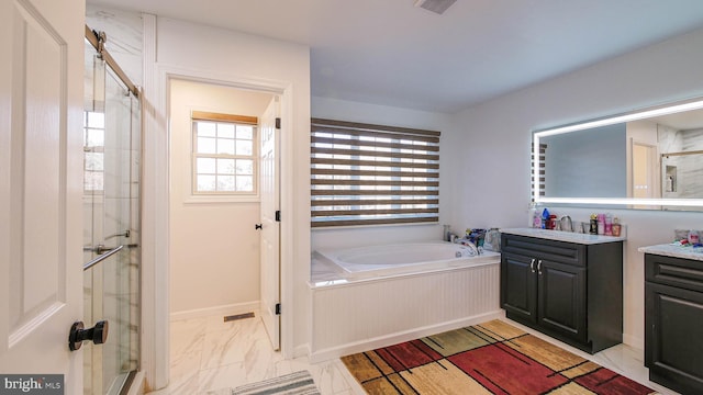 bathroom featuring vanity and shower with separate bathtub