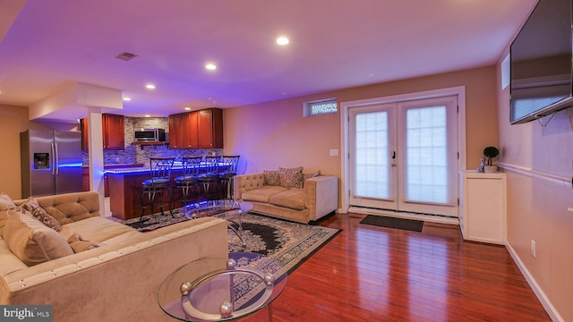 living room featuring dark hardwood / wood-style flooring and french doors