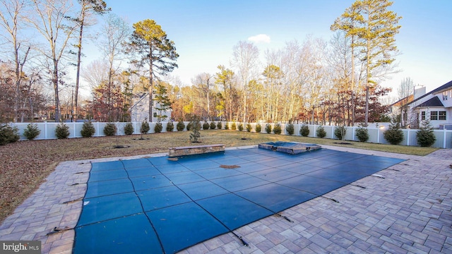 view of swimming pool with a patio area and a hot tub