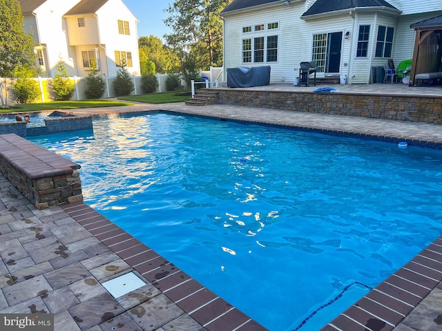 view of pool with area for grilling and a patio area