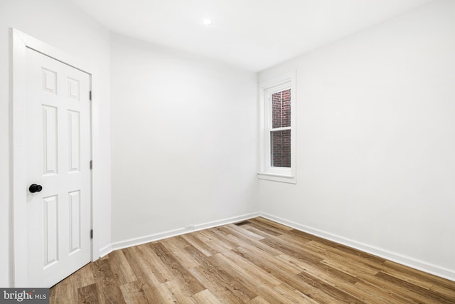 empty room with light hardwood / wood-style flooring