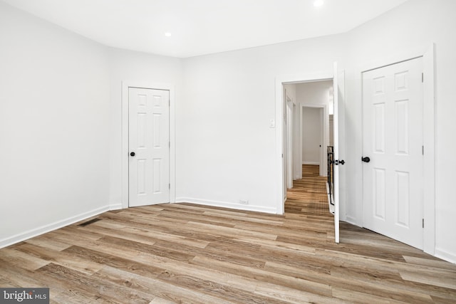 empty room with light hardwood / wood-style floors