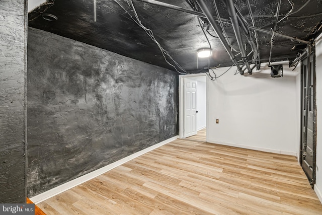 basement featuring hardwood / wood-style flooring