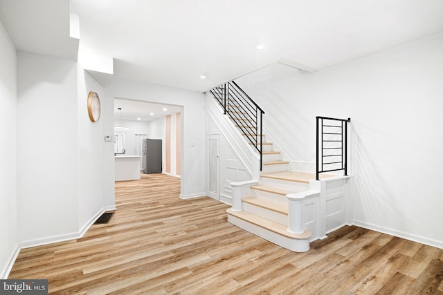 stairs featuring wood-type flooring