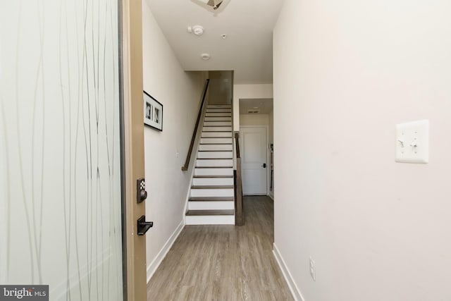 corridor with light hardwood / wood-style flooring