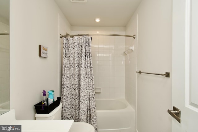 bathroom with toilet and shower / bath combo