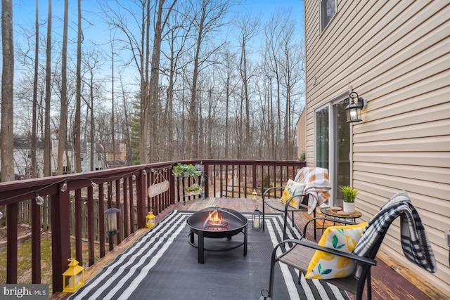 wooden deck featuring a fire pit