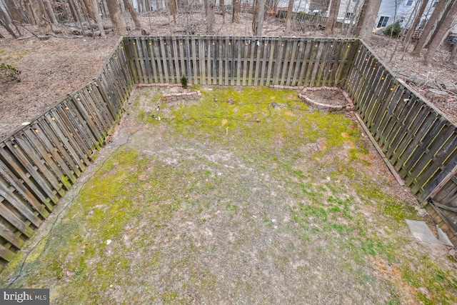 view of yard with a fenced backyard