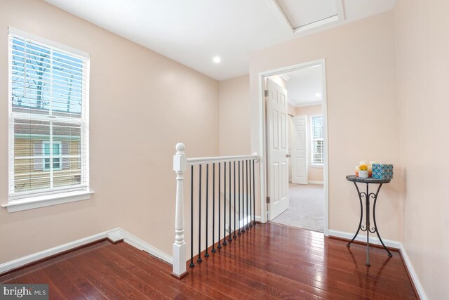 hallway featuring recessed lighting, baseboards, dark wood finished floors, and an upstairs landing