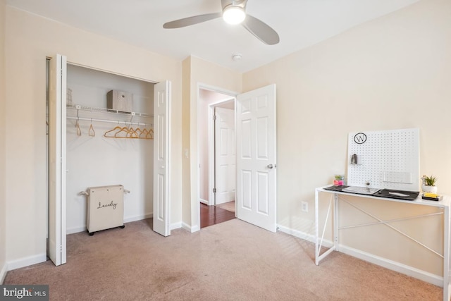 carpeted bedroom with a closet, ceiling fan, and baseboards