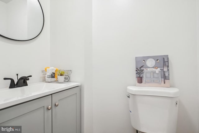 half bathroom with toilet and vanity