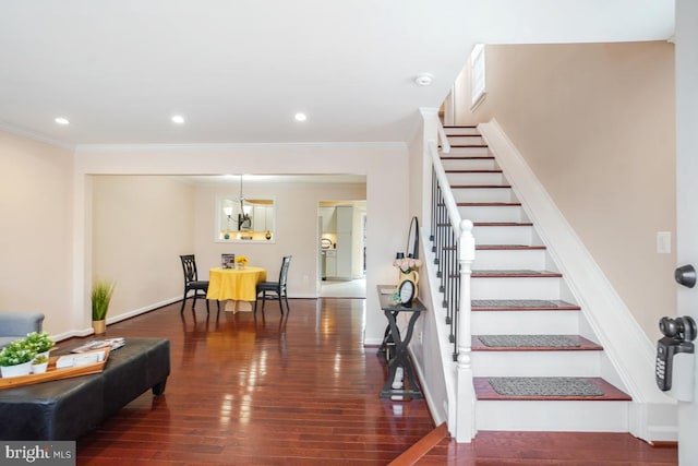 staircase with ornamental molding, recessed lighting, and wood finished floors