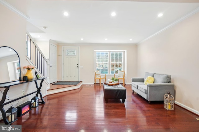 foyer entrance featuring dark wood-type flooring, crown molding, stairway, and baseboards