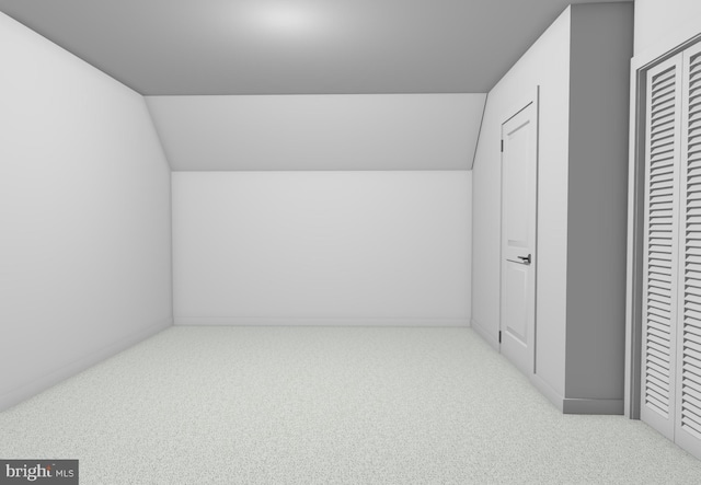 bonus room with vaulted ceiling and light colored carpet