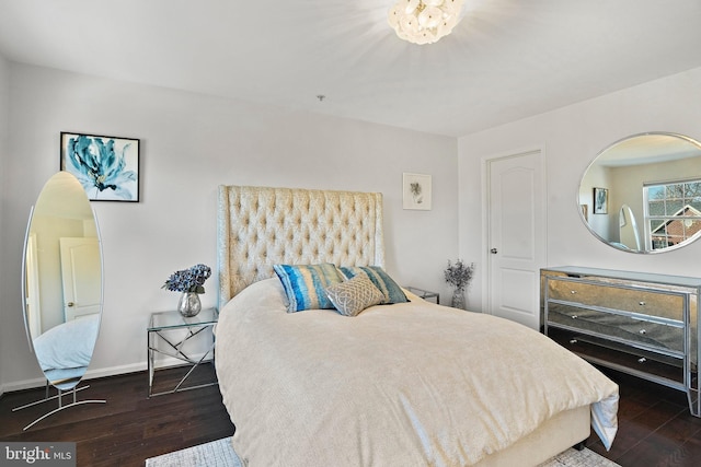 bedroom with dark hardwood / wood-style flooring