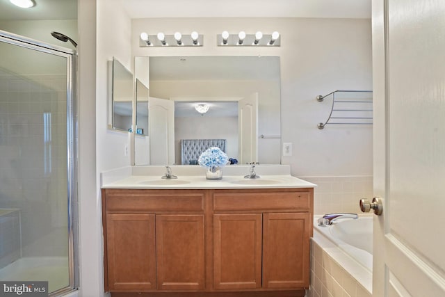 bathroom featuring vanity and separate shower and tub