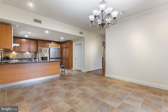 kitchen with appliances with stainless steel finishes, pendant lighting, ventilation hood, decorative backsplash, and crown molding