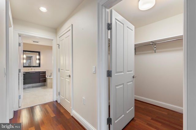 corridor with dark hardwood / wood-style floors