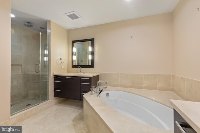 bathroom featuring vanity and independent shower and bath