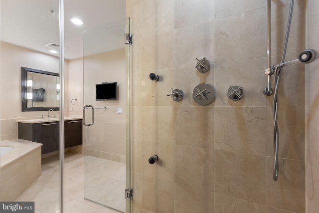 bathroom with vanity and a shower with shower door