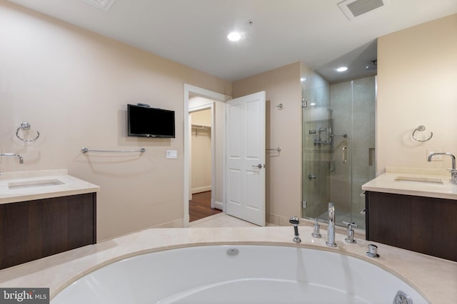 bathroom with vanity and separate shower and tub