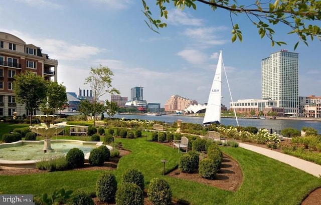 view of home's community featuring a water view and a lawn