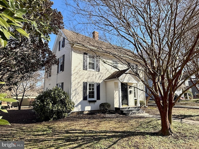 view of front of property with a front lawn and a chimney