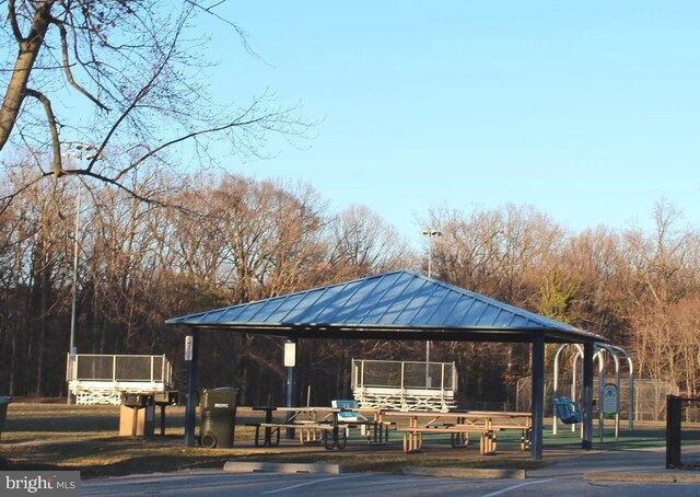 view of community with uncovered parking and a gazebo