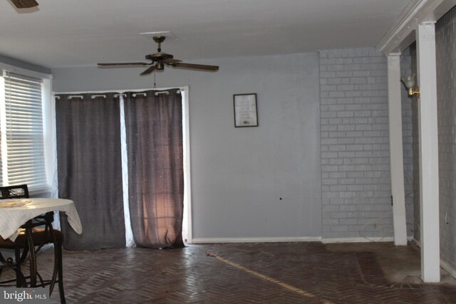 dining room featuring ceiling fan and baseboards