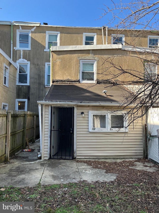 rear view of house with fence