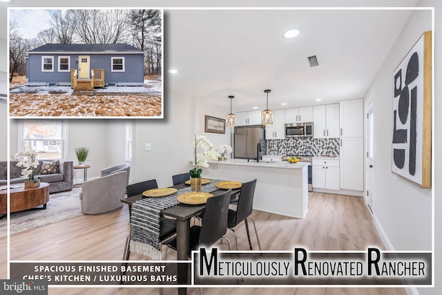 dining room with baseboards, light wood finished floors, visible vents, and recessed lighting