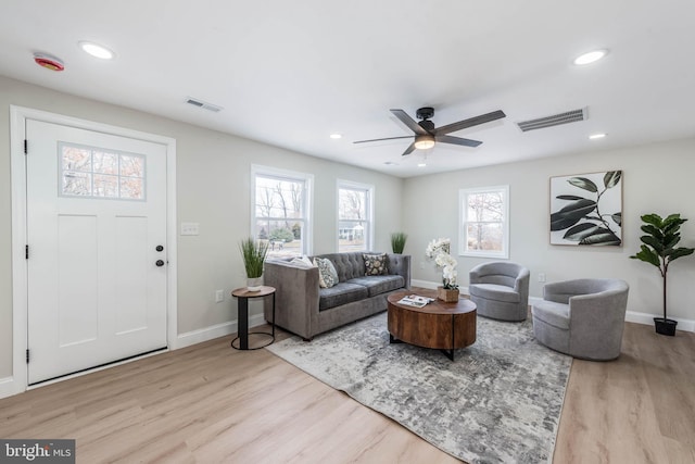 living room featuring visible vents, wood finished floors, and recessed lighting