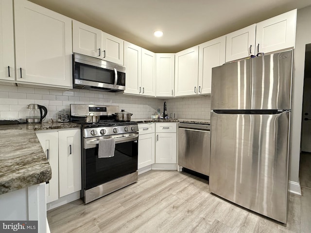 kitchen featuring light hardwood / wood-style flooring, stainless steel appliances, and white cabinets