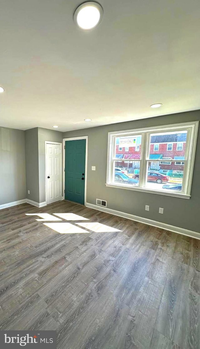 unfurnished room with recessed lighting, visible vents, baseboards, and wood finished floors