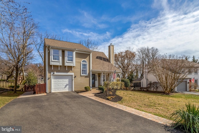 view of front of home with a front lawn, fence, aphalt driveway, a chimney, and an attached garage