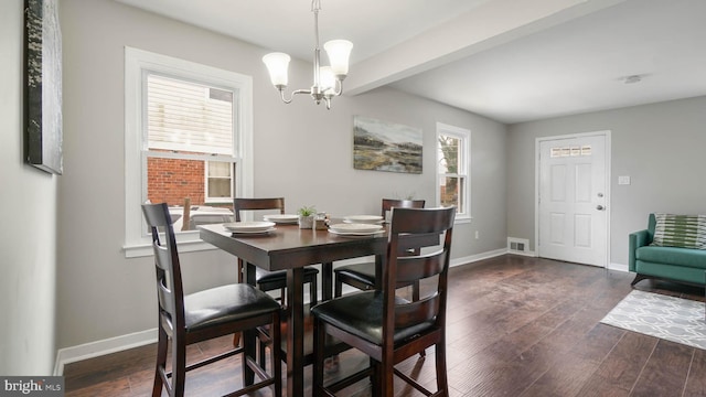 dining space featuring beamed ceiling, dark hardwood / wood-style floors, and a notable chandelier