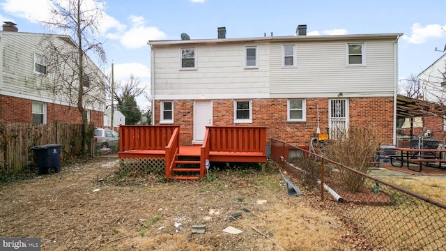 rear view of property featuring a wooden deck