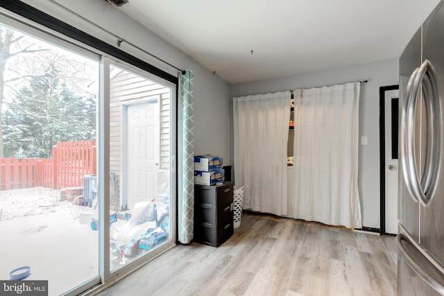 doorway with light wood-type flooring