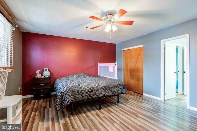 bedroom featuring hardwood / wood-style floors, a closet, and ceiling fan