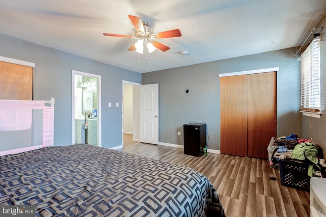 bedroom with hardwood / wood-style flooring, ceiling fan, and a closet