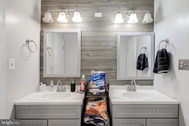 bathroom featuring vanity and wooden walls