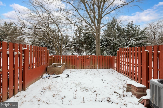 yard layered in snow featuring central AC