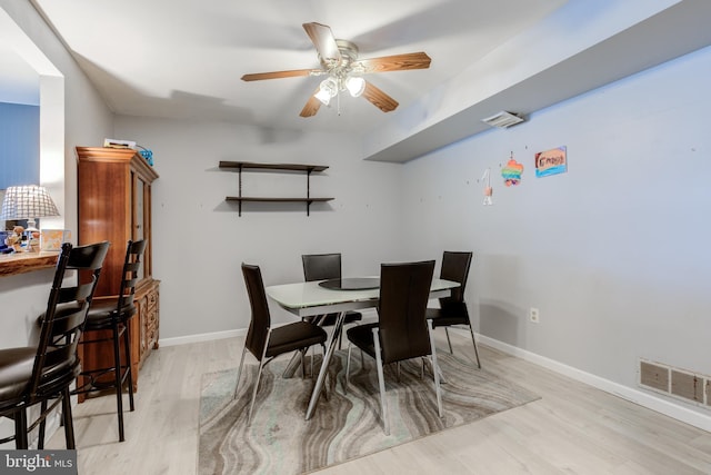 dining room with light hardwood / wood-style flooring and ceiling fan