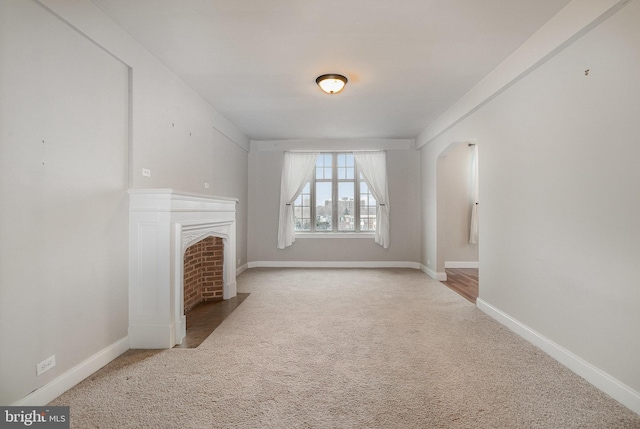 unfurnished living room featuring carpet flooring